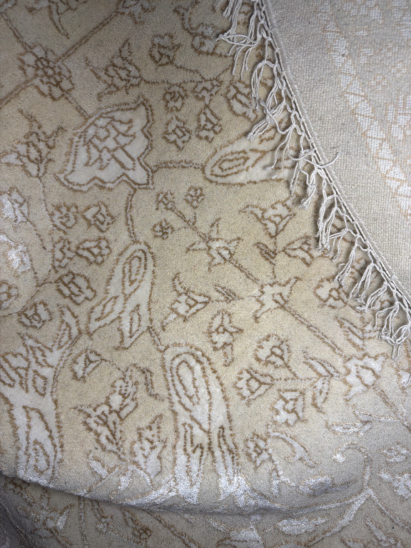 Wool and viscose round area rug with traditional paisley and floral motifs