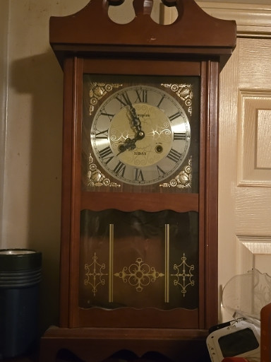 Wood wall clock with brass dial and pendulum by Wang Ja