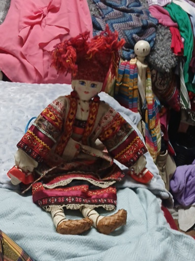 Russian folk doll in traditional costume with fabric head and body