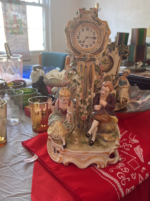 Porcelain figural mantel clock with courting couple and floral decoration