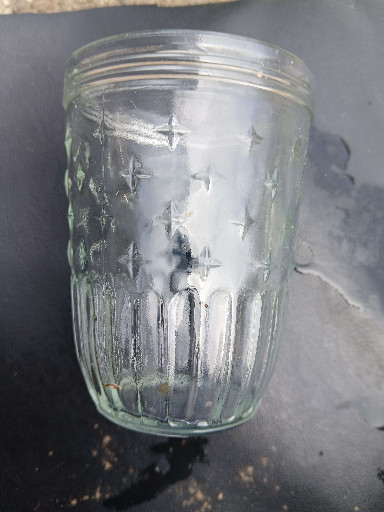Clear glass jelly jar with starburst pattern, likely Kerr brand