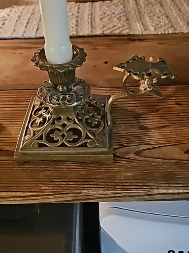 Brass chamberstick candleholder with ornate pierced base and finger loop