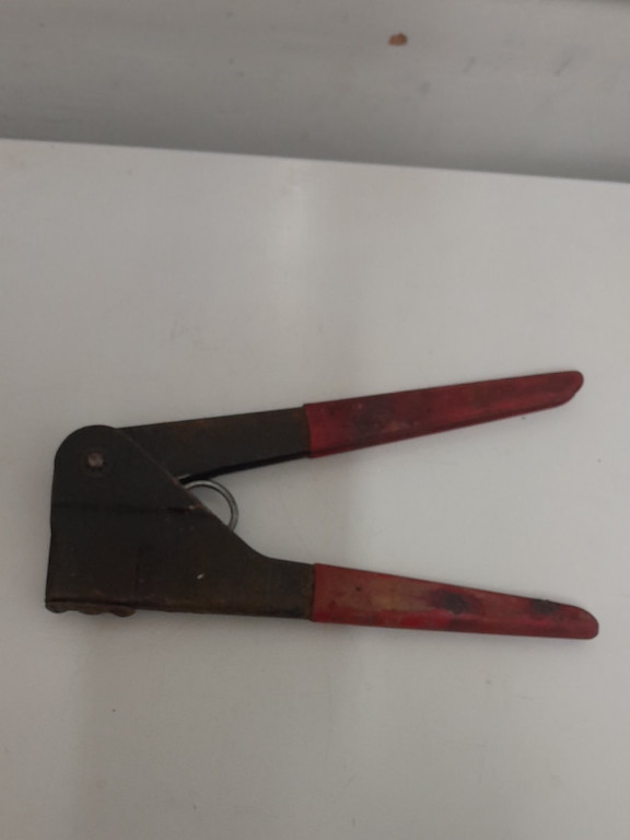 Metal hand riveter tool with red plastic handles