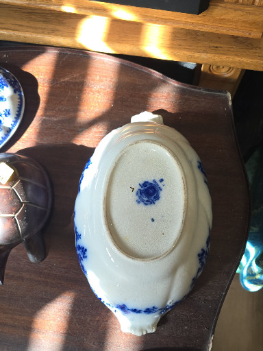 Ceramic sauce tureen or gravy boat with lid, featuring blue transfer-printed floral decoration on white earthenware