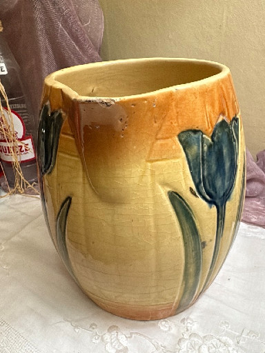 Ceramic pitcher with hand-painted blue tulip design by Roseville Pottery