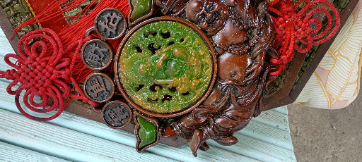 Chinese decorative wall hanging with faux jade centerpiece and carved wooden dragon frame