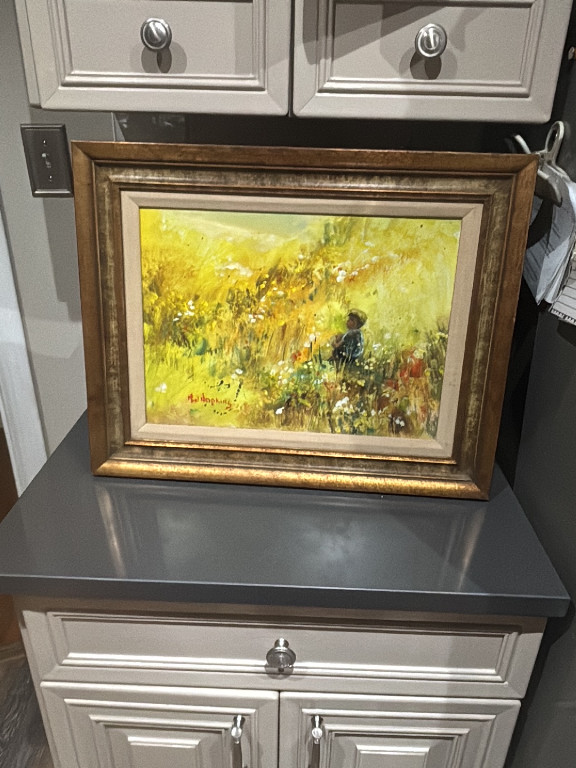 Oil on canvas landscape painting depicting a figure in a wildflower meadow, signed lower left