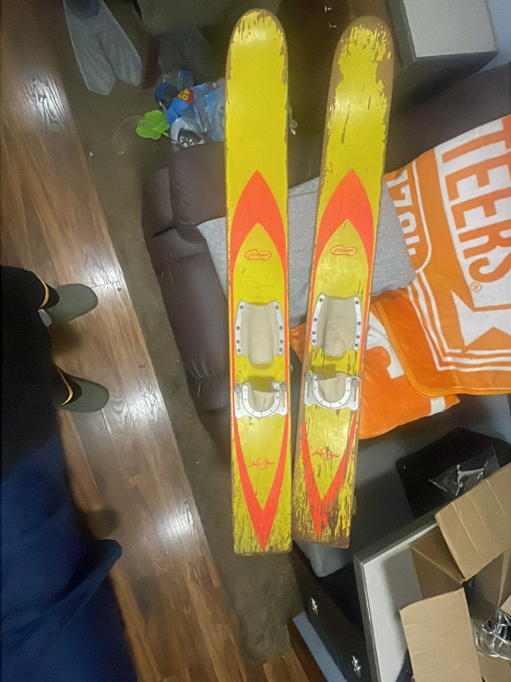 Vintage wooden water skis with yellow and orange flame design