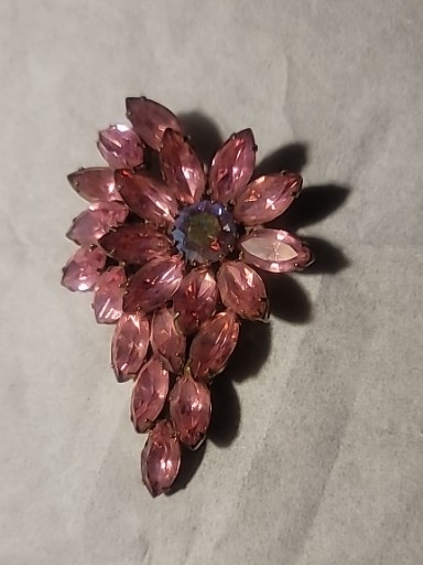 Vintage pink rhinestone floral spray brooch with aurora borealis center stone, likely Juliana style