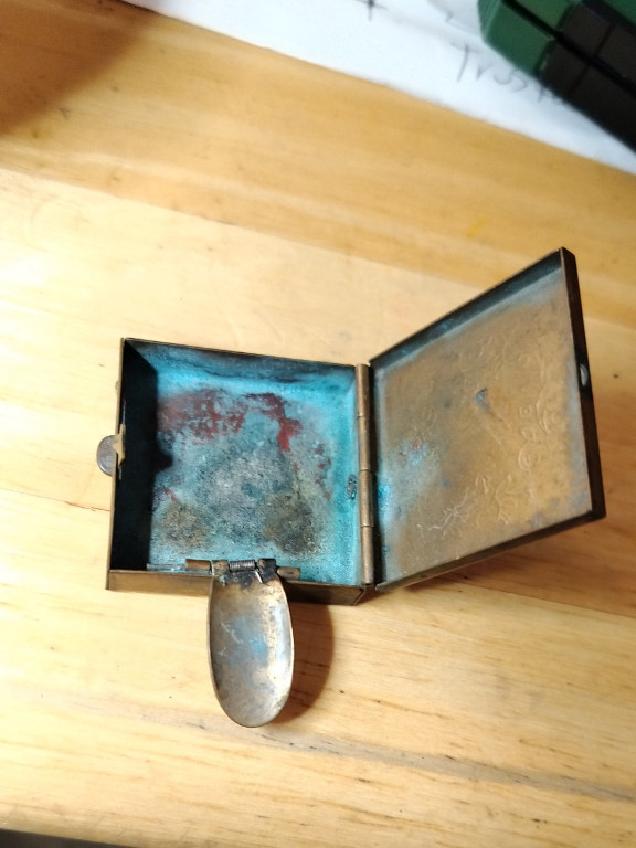 Brass pocket ashtray with hinged lid and verdigris patina