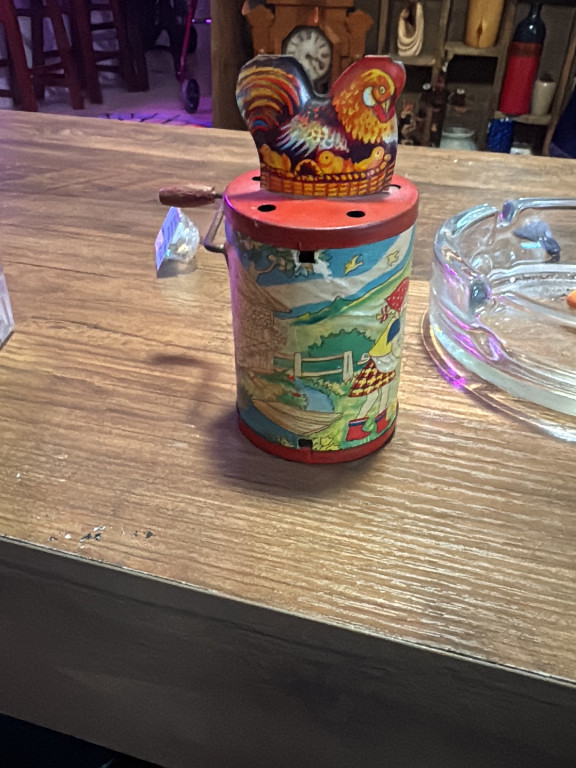 Tin lithograph wind-up toy titled 'Clucking Hen on Drum' by German manufacturer