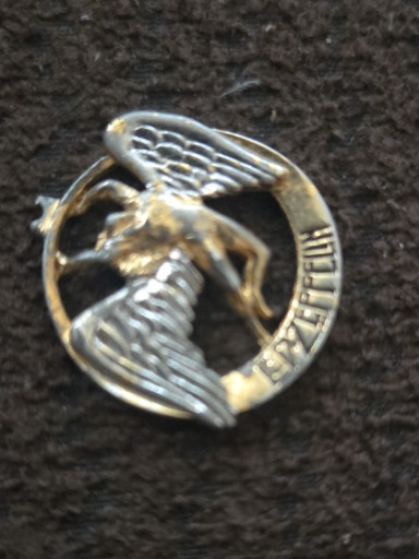 Metal pin badge featuring Led Zeppelin's 'Swan Song' logo with winged angel figure