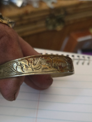 Sterling silver bangle bracelet with engraved elephant and floral motifs