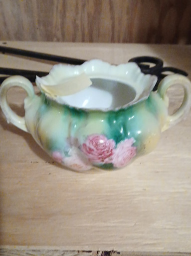 Porcelain sugar bowl with hand-painted floral decoration and ruffled rim.  This piece is by RS from Prussia.