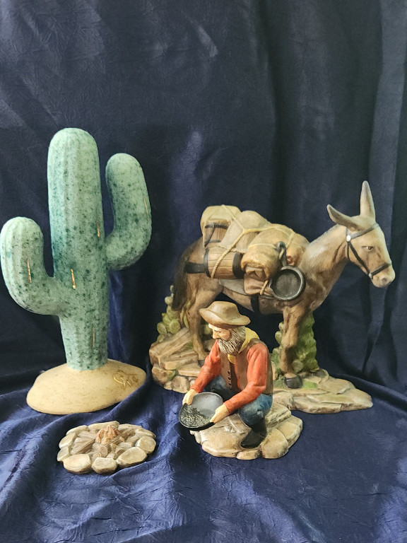 Ceramic figurine set of a gold prospector with donkey, cactus and campfire