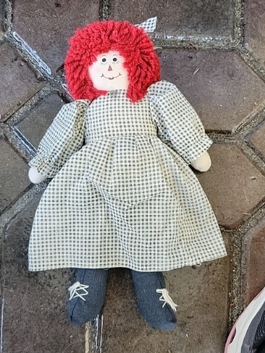Handmade cloth doll resembling 'Raggedy Ann' with red yarn hair and gingham dress