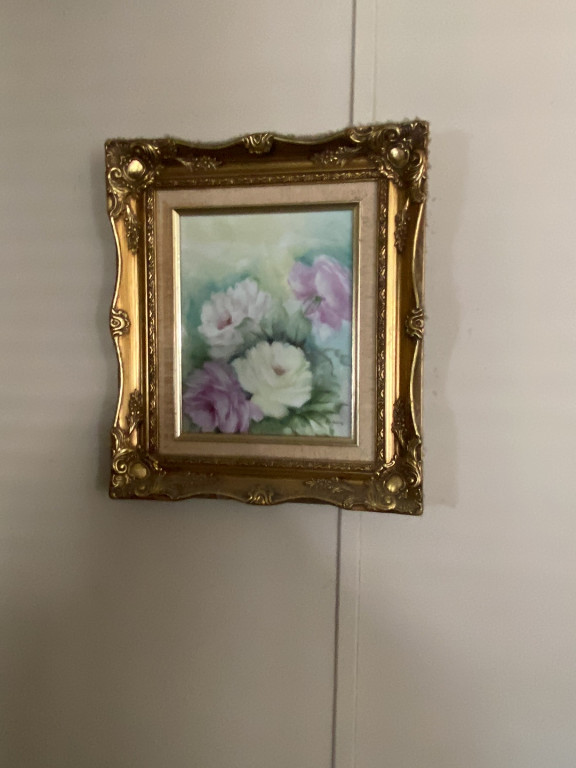 Hand-painted porcelain plaque depicting roses in an ornate gilded frame