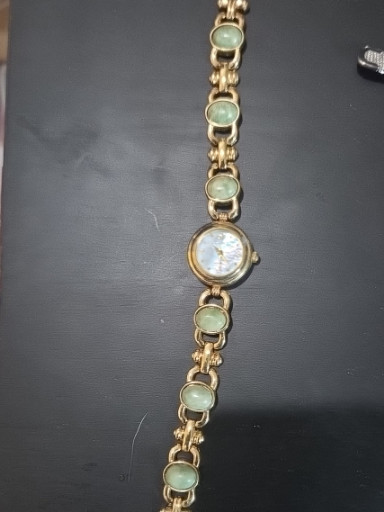 Gold-tone bracelet watch with jade cabochon stones