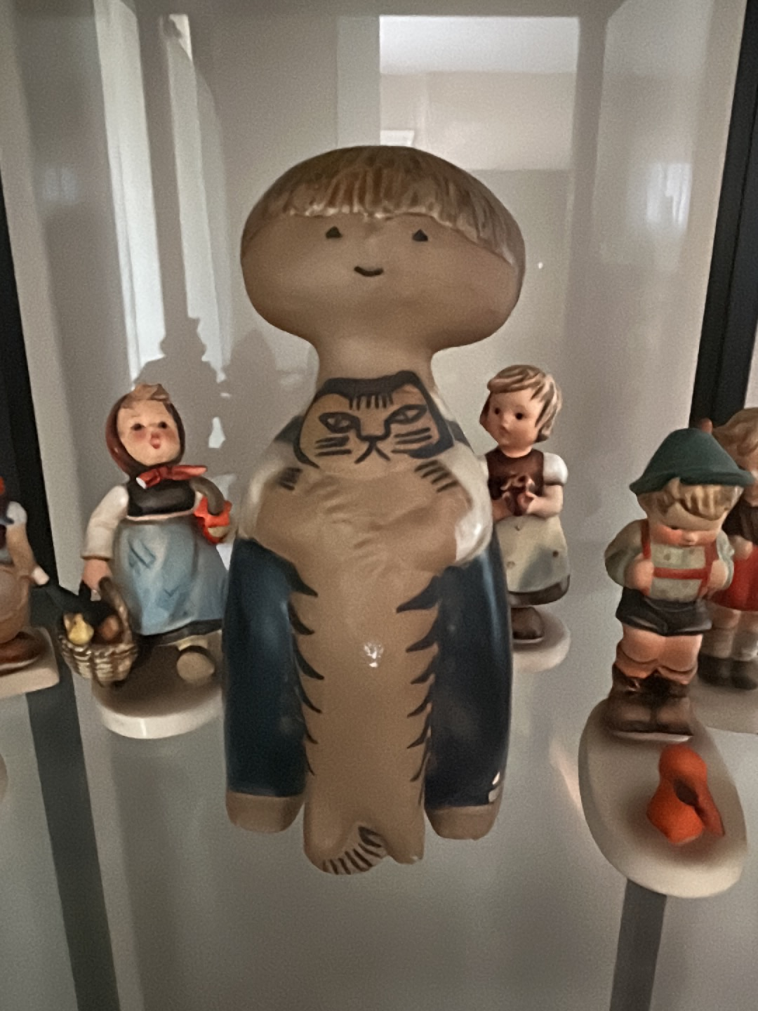 Ceramic figurine titled 'Pelle with Cat' by Lisa Larson