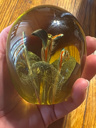 Glass paperweight with internal floral design and controlled bubbles