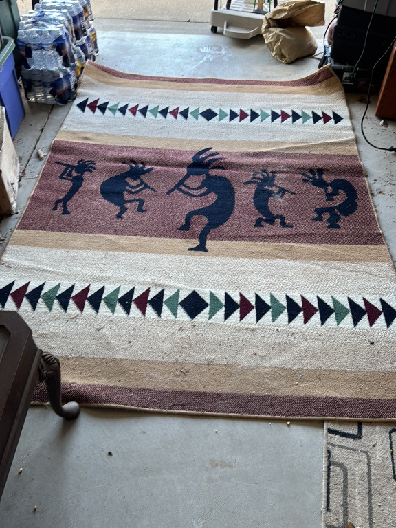 Wool rug featuring Kokopelli figures in Southwestern Native American style