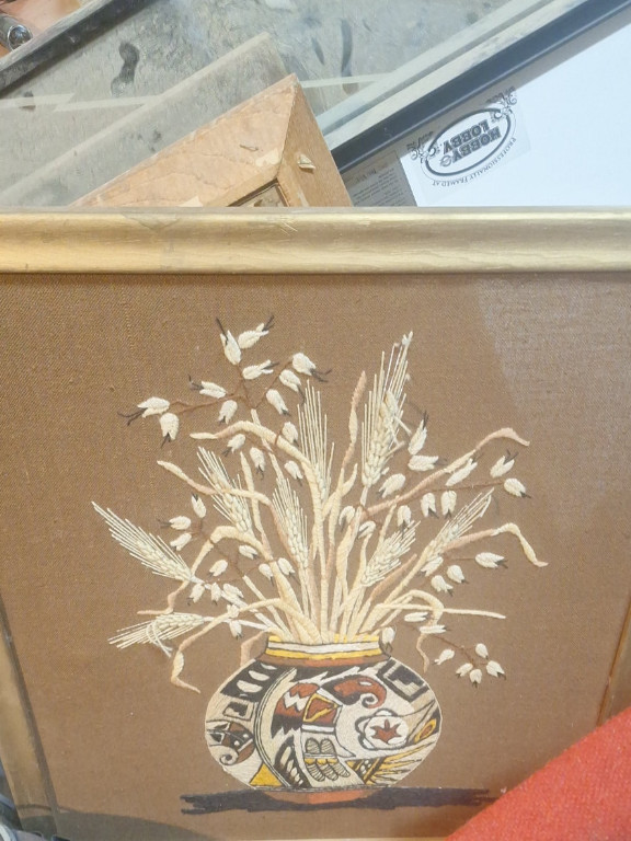 Embroidered textile artwork featuring a Native American pottery vase with wheat and flowers