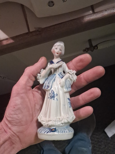 Porcelain figurine of a Victorian lady in blue and white dress
