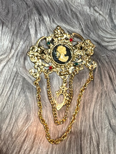 Gold-tone metal brooch with cameo and chain swags, West Germany