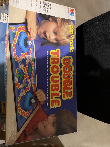 Board game titled 'Pop-O-Matic Double Trouble' by Milton Bradley