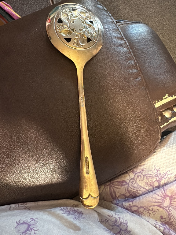 Silver-plated serving spoon with pierced floral design by Leonard, Italy