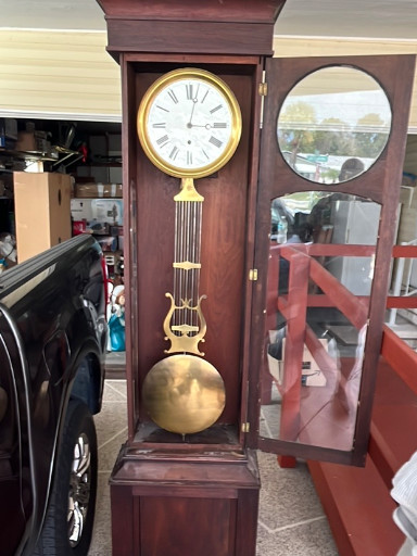 Mahogany wall-mounted regulator clock with brass lyre pendulum and white enamel dial