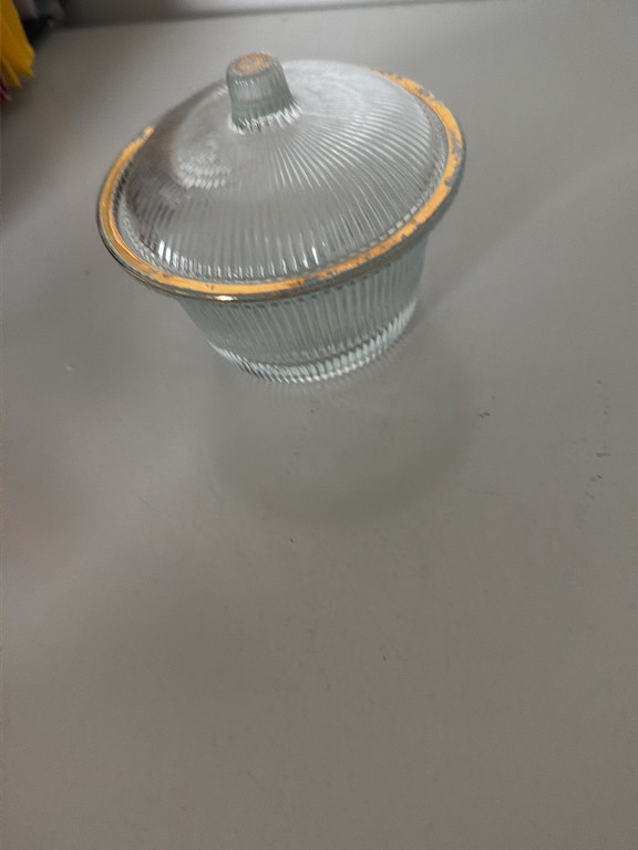 Ribbed glass candy dish with gold trim and lid