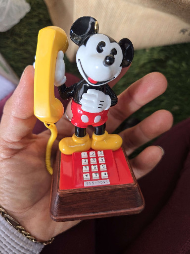 Vintage Mickey Mouse push-button telephone with yellow handset, manufactured by American Telecommunications Corporation (ATC) under Disney license