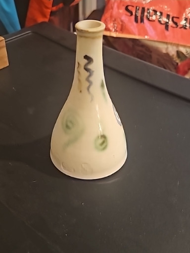 Ceramic bud vase with painted shamrock or leaf motif