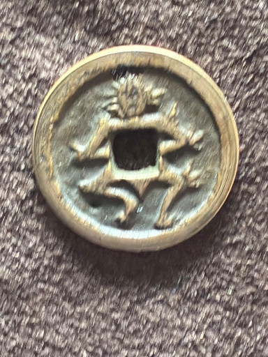 Bronze Chinese zodiac charm featuring an ox or cattle motif