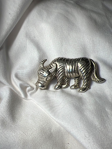 Silver-tone metal brooch depicting a buffalo or bull