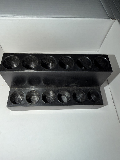 Black plastic display organizer with twelve circular compartments