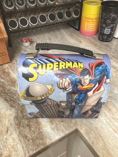 Metal dome-shaped lunch box featuring Superman by The Tin Box Company