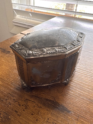 Silver-plated metal jewelry box with repousse decoration by Jennings Brothers