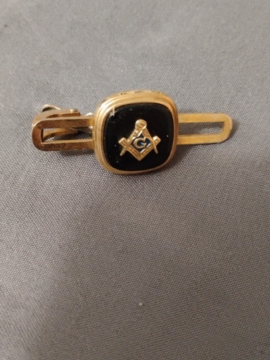 Gold-tone tie clip with black enamel Masonic square and compass emblem