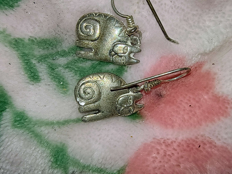 Sterling silver earrings featuring stylized Aztec or Mayan rabbit designs