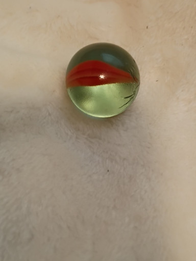 Glass marble with multicolored swirl pattern