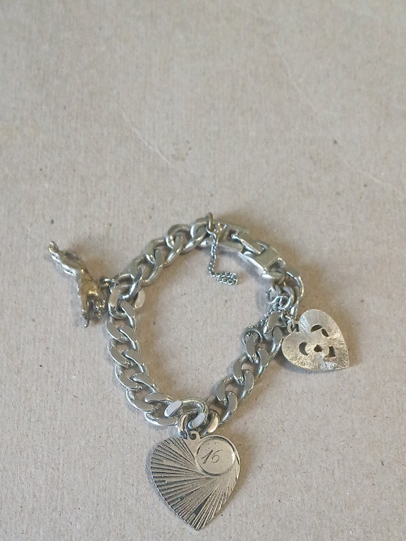 Silver charm bracelet with heart-shaped charms