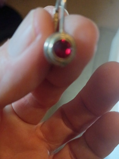 Sterling silver lever-back earring with bezel-set red gemstone (likely garnet or synthetic ruby)