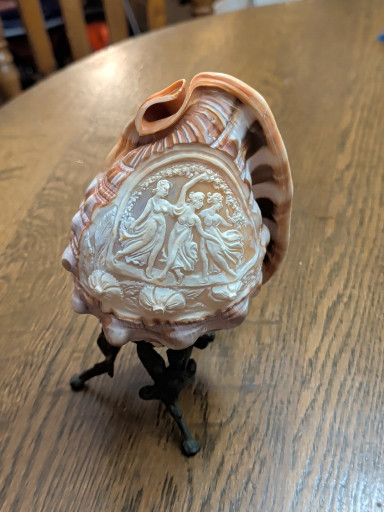 Hand-carved cameo conch shell depicting classical figures