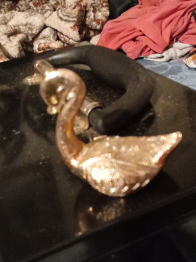 Vintage gold-tone metal swan brooch with rhinestone accents