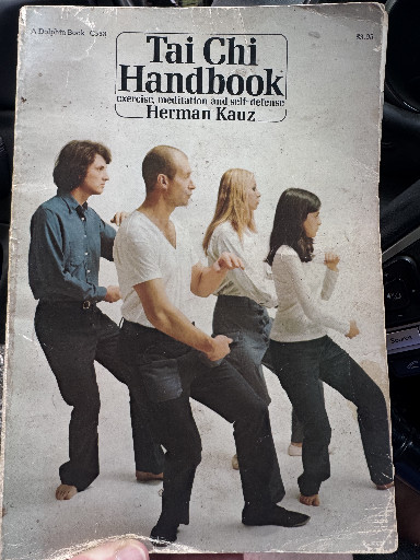 Paperback book titled 'Tai Chi Handbook: Exercise, Meditation and Self-Defense' by Herman Kauz