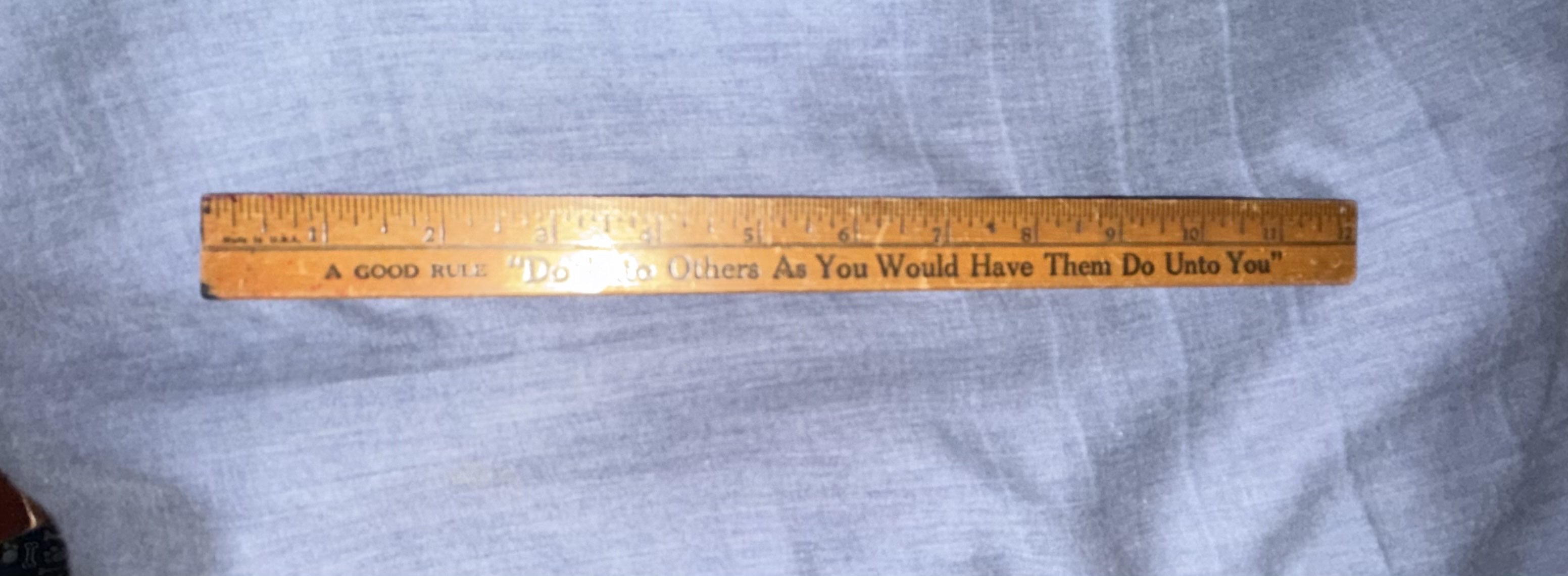 Wooden ruler with inscription 'A GOOD RULE "Do Unto Others As You Would Have Them Do Unto You"' by Coca-Cola Bottling Company