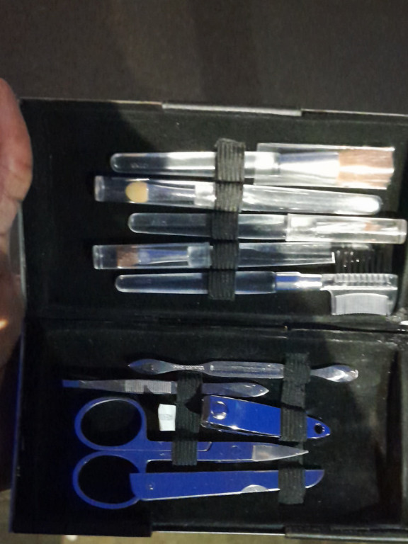 Portable manicure and grooming kit with leather travel case