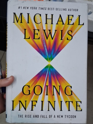 Hardcover book titled 'Going Infinite: The Rise and Fall of a New Tycoon' by Michael Lewis